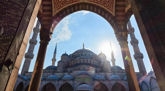 View of a Turkish mosque through a stone archway